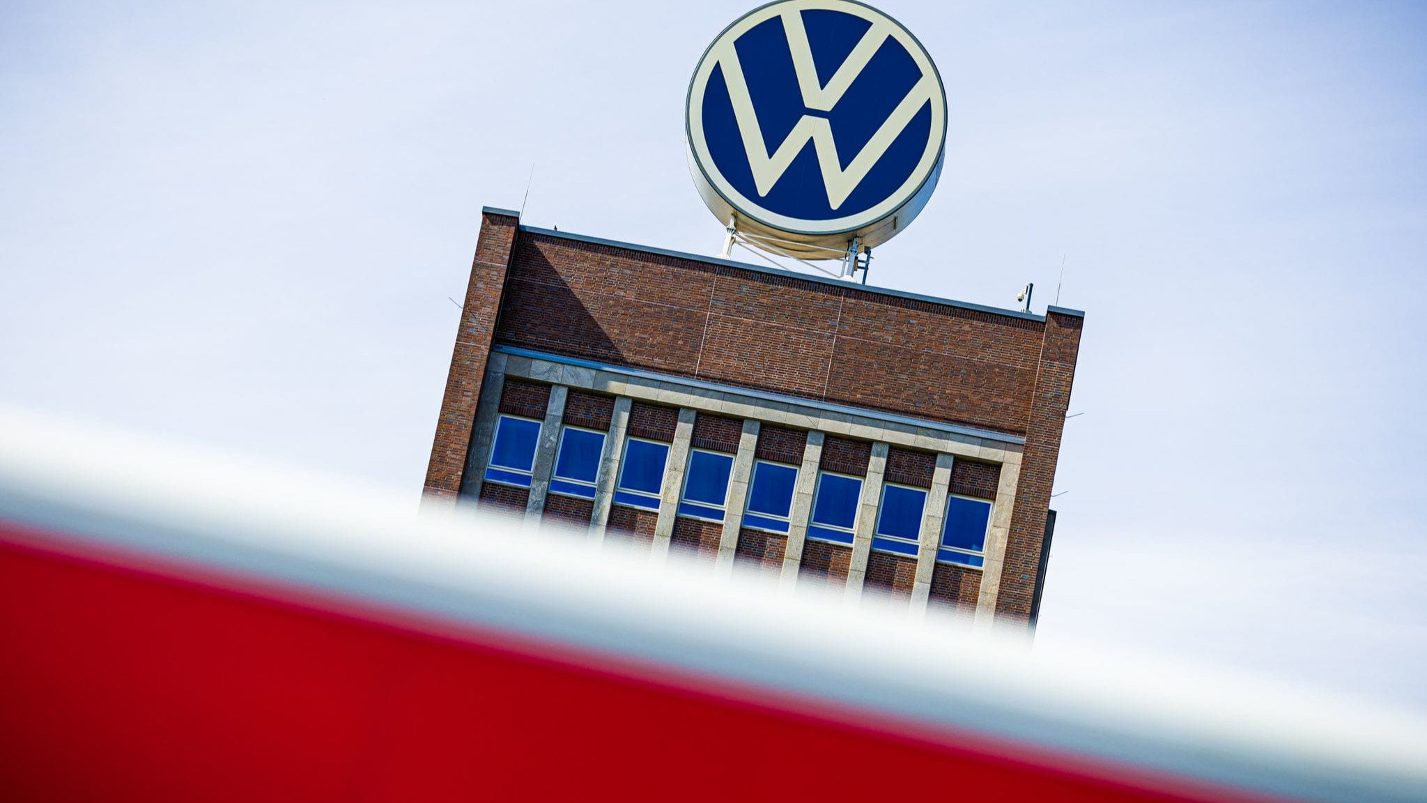 The Volkswagen logo on top of a building.